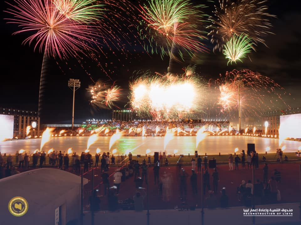 May be an image of 1 person, fireworks, crowd and text